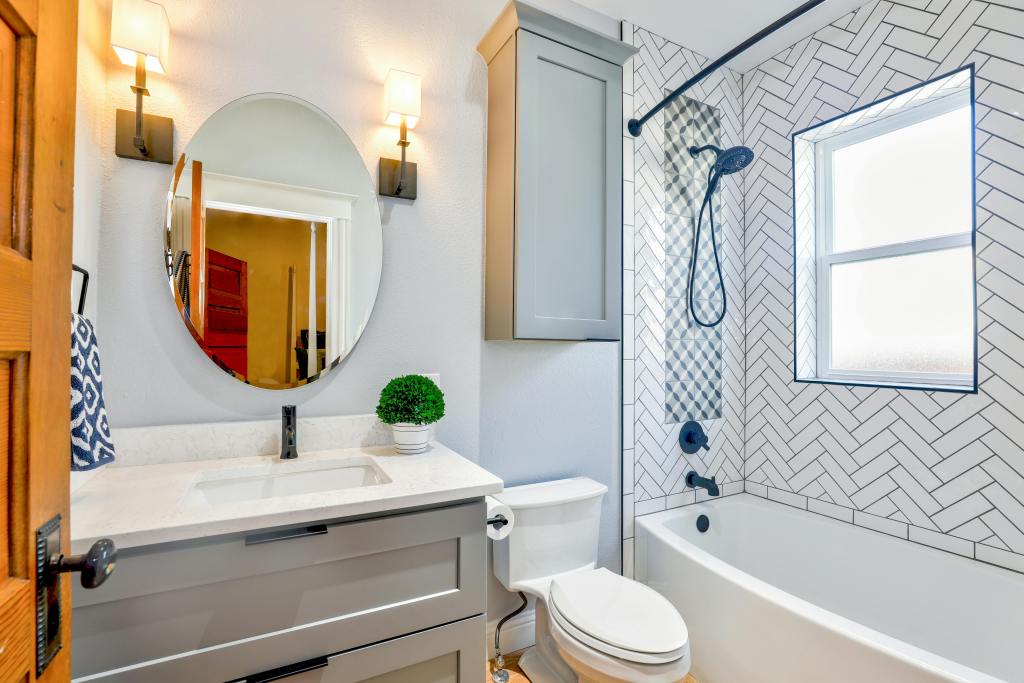 Bathroom lighting ideas for Raleigh homeowners featuring modern vanity fixtures that provide even, shadow-free lighting for daily routines.